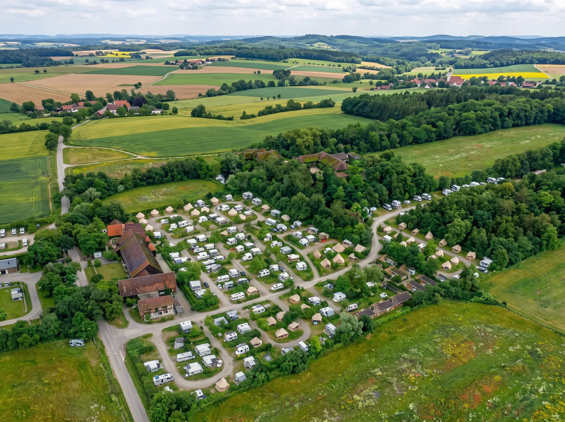 Camp between meadows and forest in the Alpine foothills